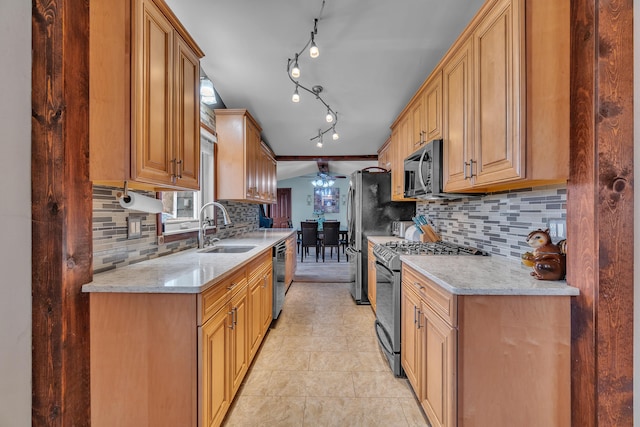 kitchen with a ceiling fan, a sink, light stone counters, backsplash, and stainless steel appliances