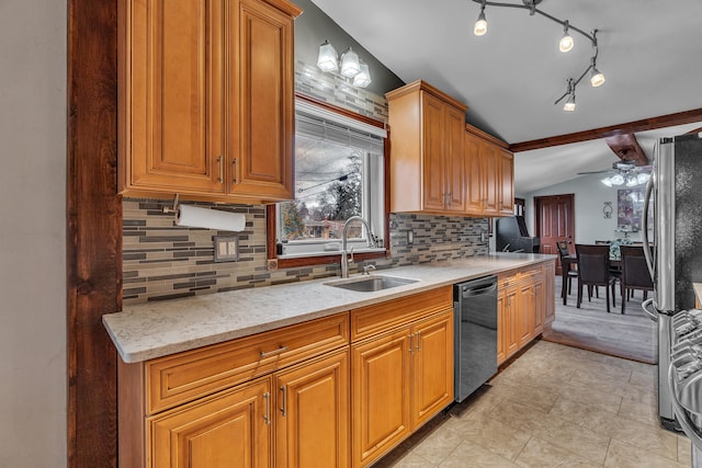 kitchen with vaulted ceiling with beams, light stone counters, decorative backsplash, appliances with stainless steel finishes, and a sink