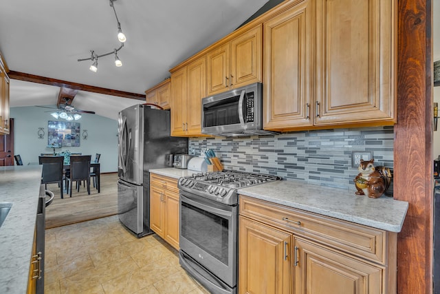 kitchen with vaulted ceiling with beams, light tile patterned floors, decorative backsplash, stainless steel appliances, and a ceiling fan