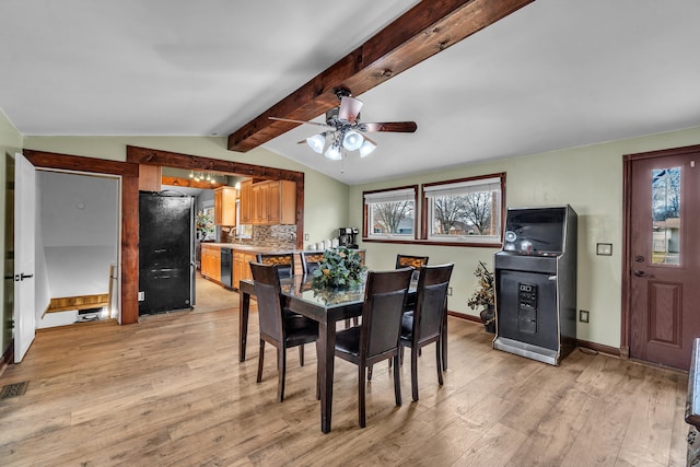 dining room with visible vents, baseboards, vaulted ceiling with beams, ceiling fan, and light wood-style floors