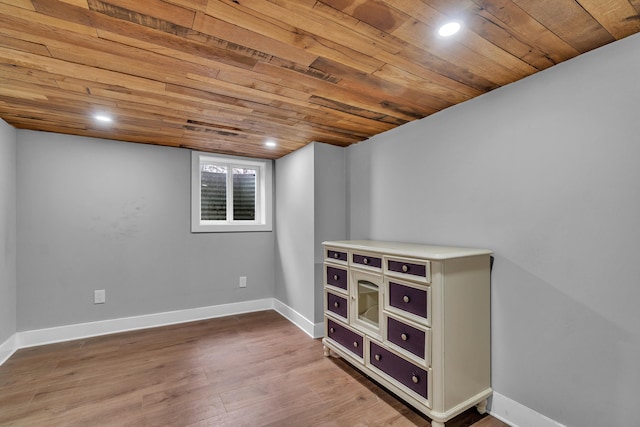 below grade area featuring recessed lighting, wooden ceiling, baseboards, and wood finished floors