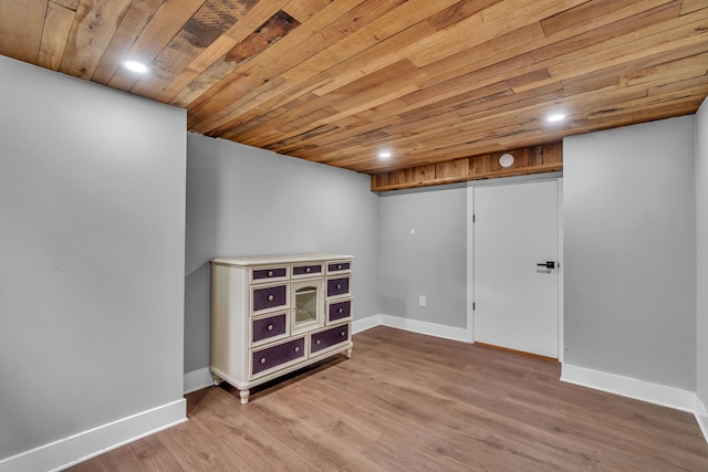 finished below grade area featuring recessed lighting, wooden ceiling, baseboards, and wood finished floors