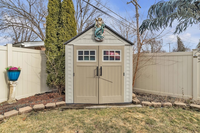 view of shed with a fenced backyard