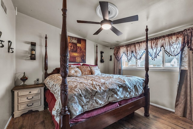 bedroom with wood finished floors, visible vents, baseboards, lofted ceiling, and ceiling fan