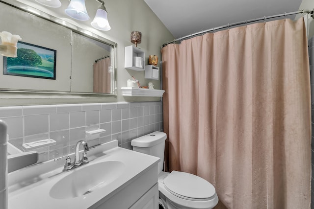 bathroom featuring tile walls, toilet, and vanity