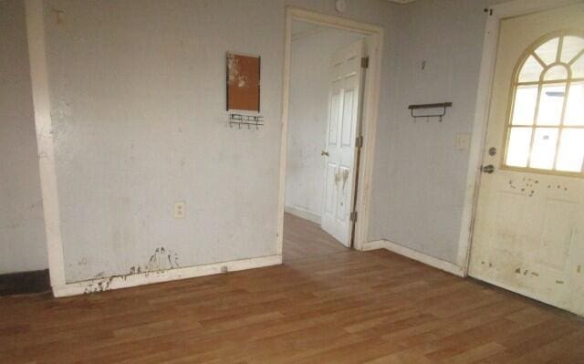 unfurnished room with wood finished floors