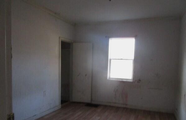 empty room with wood finished floors