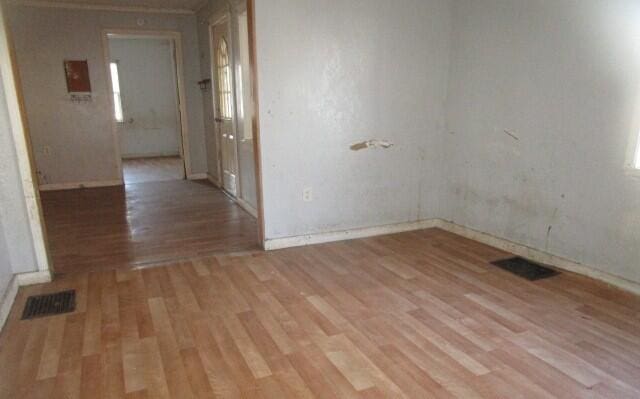 spare room with light wood-type flooring and visible vents