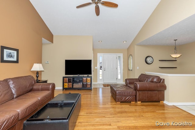 living room with light wood-style flooring, baseboards, lofted ceiling, and ceiling fan