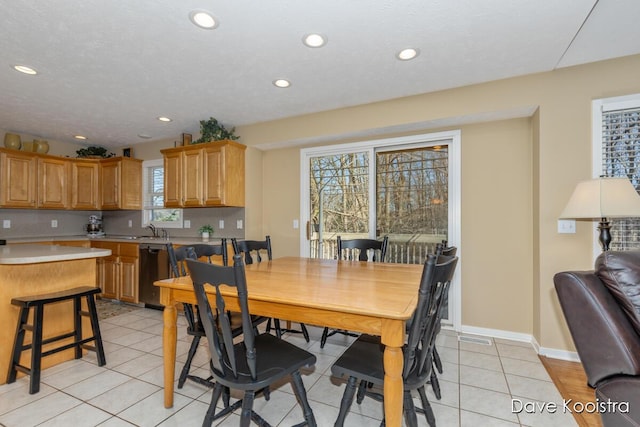 dining room with light tile patterned floors, recessed lighting, and baseboards