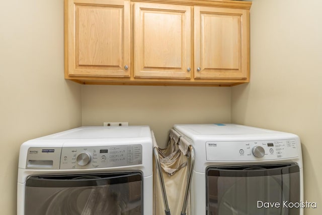 laundry room with washer and dryer and cabinet space