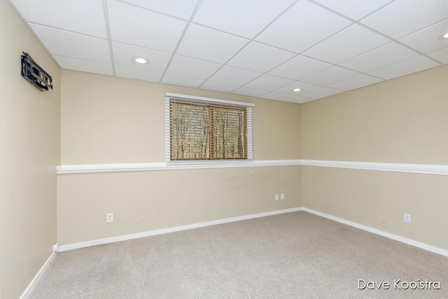 carpeted spare room featuring recessed lighting, baseboards, and a drop ceiling