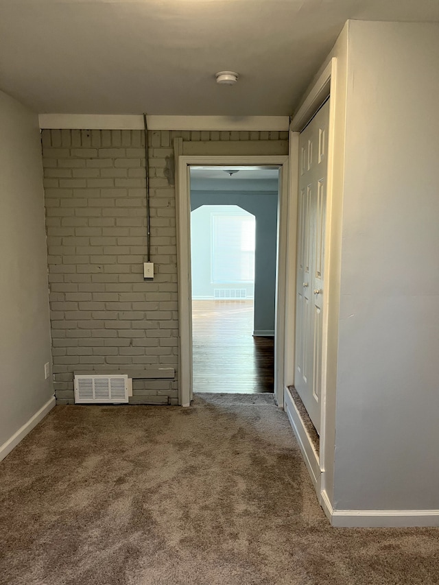 carpeted empty room with baseboards and visible vents