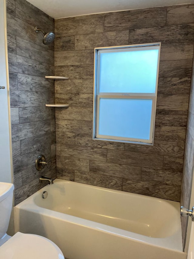 bathroom with toilet and  shower combination