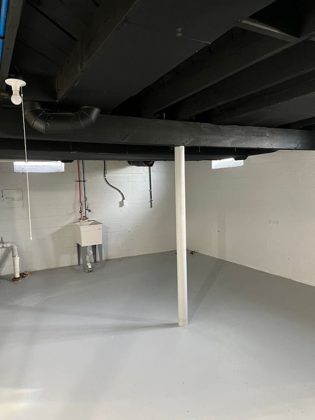 unfinished basement featuring a sink