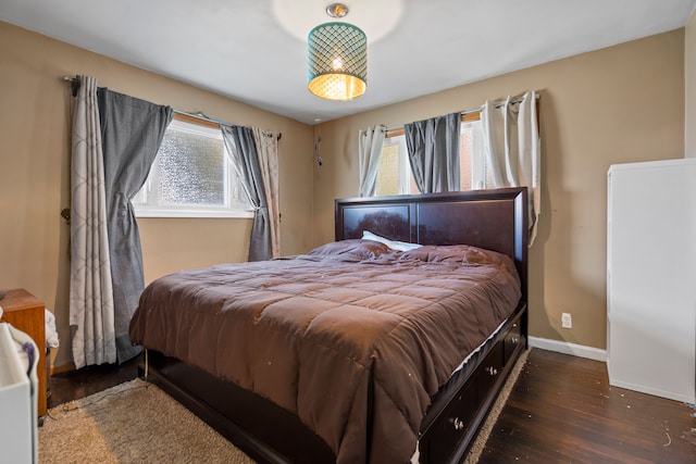 bedroom featuring wood finished floors and baseboards