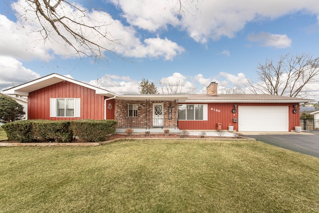 single story home with a front lawn, aphalt driveway, covered porch, a garage, and a chimney