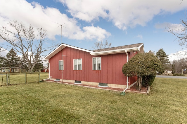 view of home's exterior featuring a yard and fence