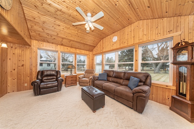 carpeted living room featuring lofted ceiling, wooden walls, wood ceiling, and ceiling fan