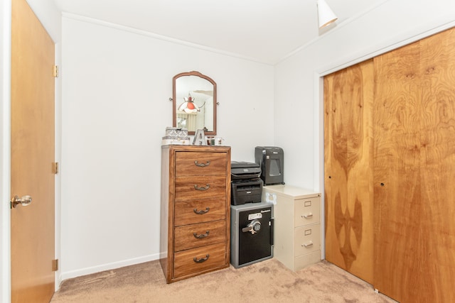 office area with crown molding, light colored carpet, and baseboards