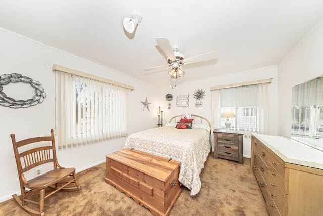 bedroom with multiple windows, light colored carpet, and baseboards