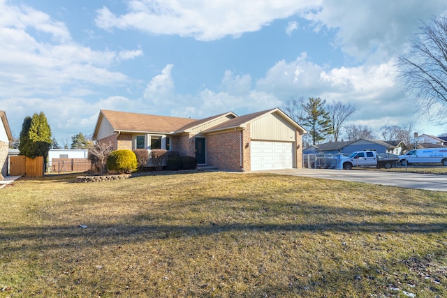 ranch-style house with concrete driveway, fence, brick siding, and a front lawn