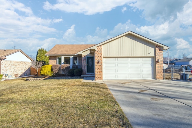 view of front of house with a front lawn, driveway, fence, an attached garage, and brick siding