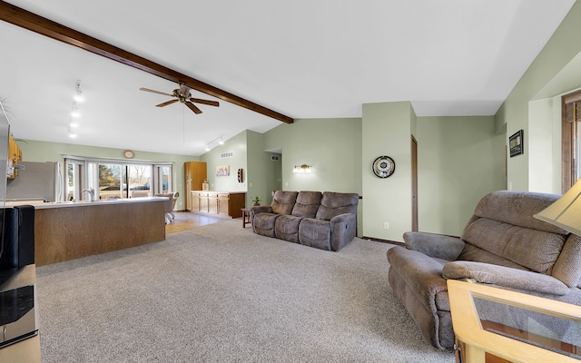 living room featuring a ceiling fan, baseboards, visible vents, lofted ceiling with beams, and light carpet