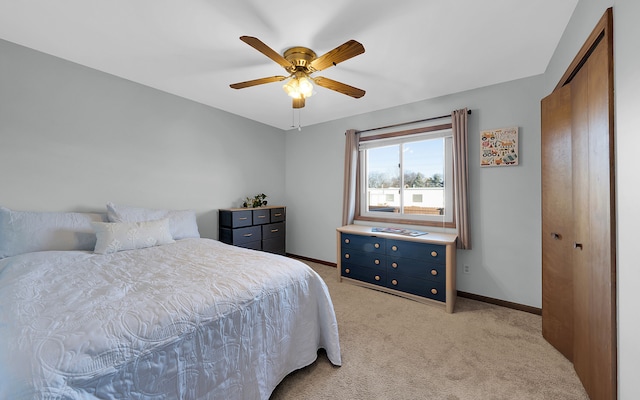 bedroom featuring light colored carpet, baseboards, and ceiling fan