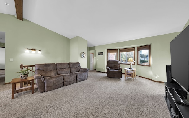 carpeted living room featuring lofted ceiling with beams and baseboards