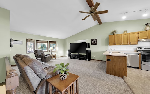 living room featuring baseboards, lofted ceiling with beams, ceiling fan, rail lighting, and light colored carpet