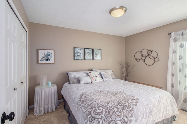 bedroom featuring a closet, baseboards, and carpet flooring