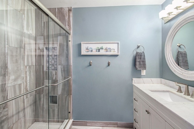 full bath featuring a stall shower and vanity