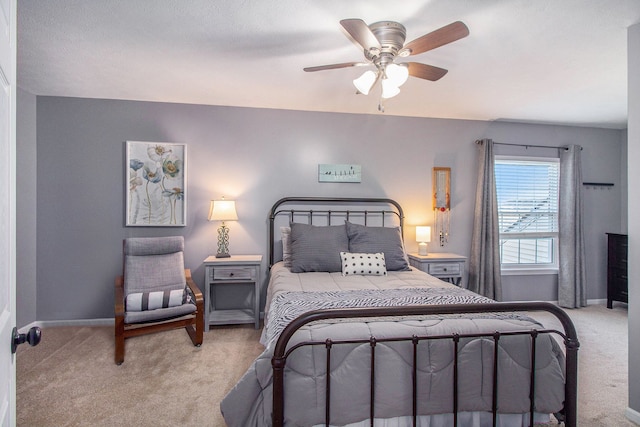 bedroom with ceiling fan, baseboards, and light carpet