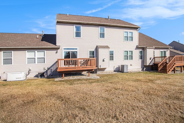 back of house featuring a wooden deck, a lawn, central AC, and roof with shingles