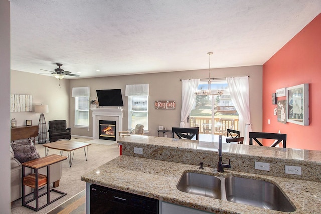 kitchen with plenty of natural light, carpet flooring, dishwasher, and a sink