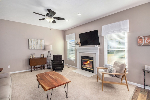 carpeted living room featuring a wealth of natural light, a fireplace, and baseboards