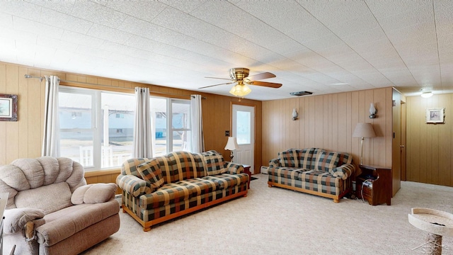 carpeted living room with a ceiling fan