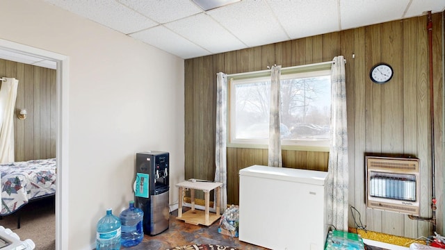 clothes washing area with heating unit and wood walls