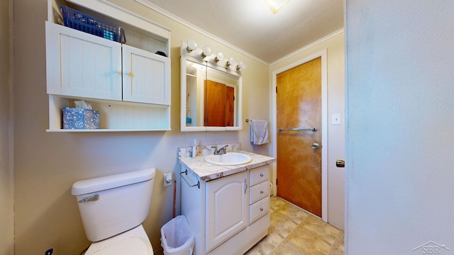 bathroom with vanity, toilet, and ornamental molding