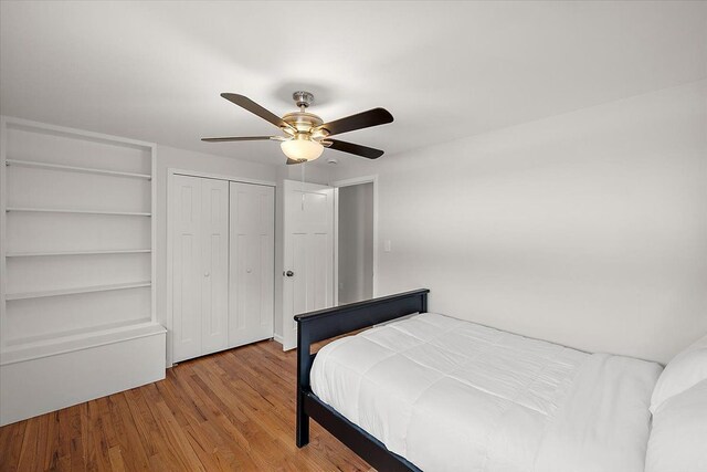 bedroom with a closet, ceiling fan, and wood finished floors