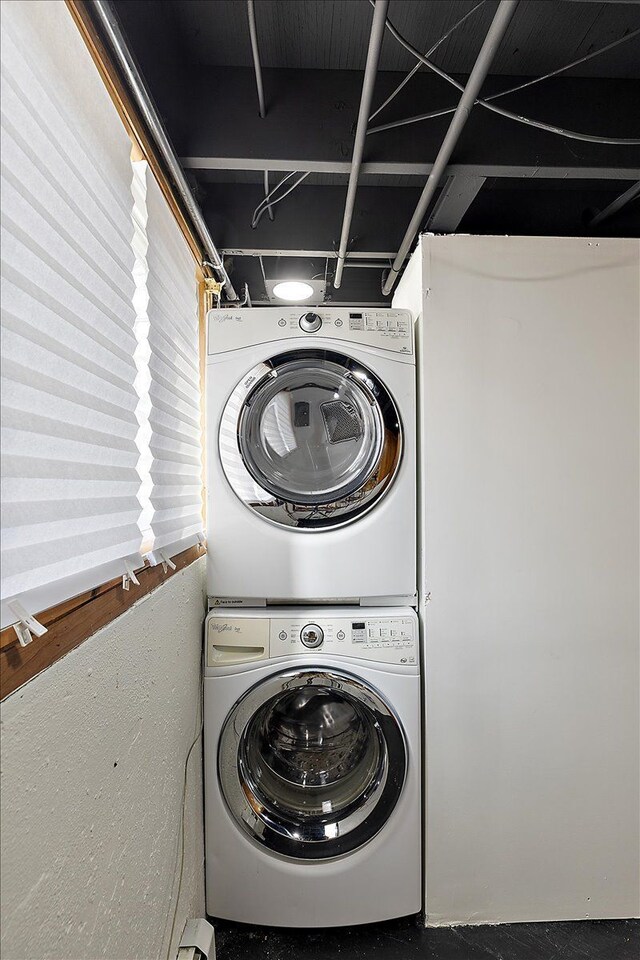 washroom featuring laundry area and stacked washing maching and dryer