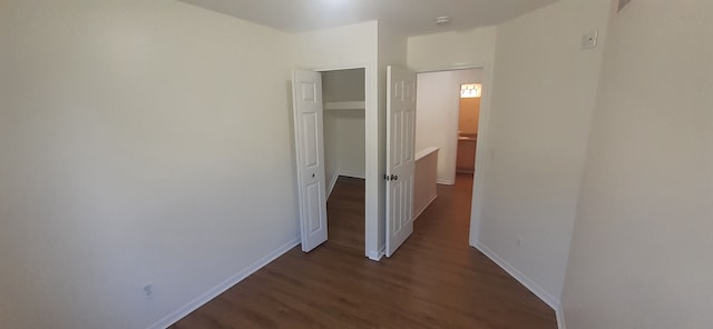 interior space with baseboards and wood finished floors