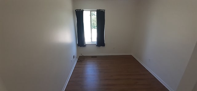 empty room featuring a wealth of natural light and baseboards