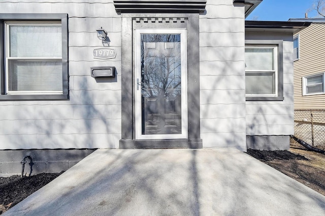 doorway to property featuring fence