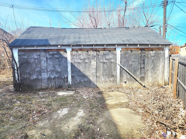 view of outdoor structure with an outbuilding and fence