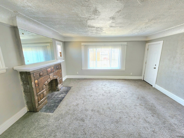 unfurnished living room featuring plenty of natural light, carpet, and baseboards