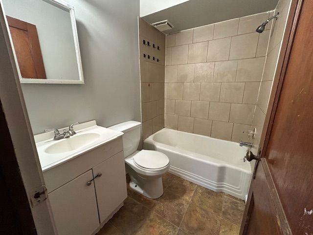 full bath featuring vanity, toilet, tub / shower combination, and visible vents