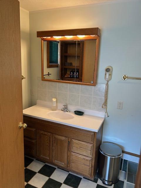 bathroom with tile patterned floors, backsplash, and vanity