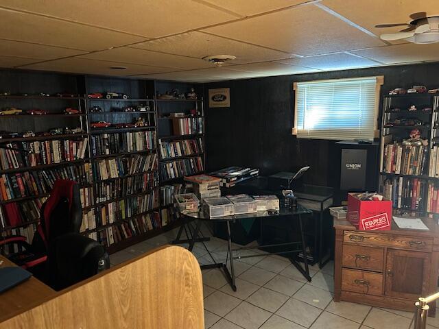 tiled office featuring a ceiling fan and a drop ceiling